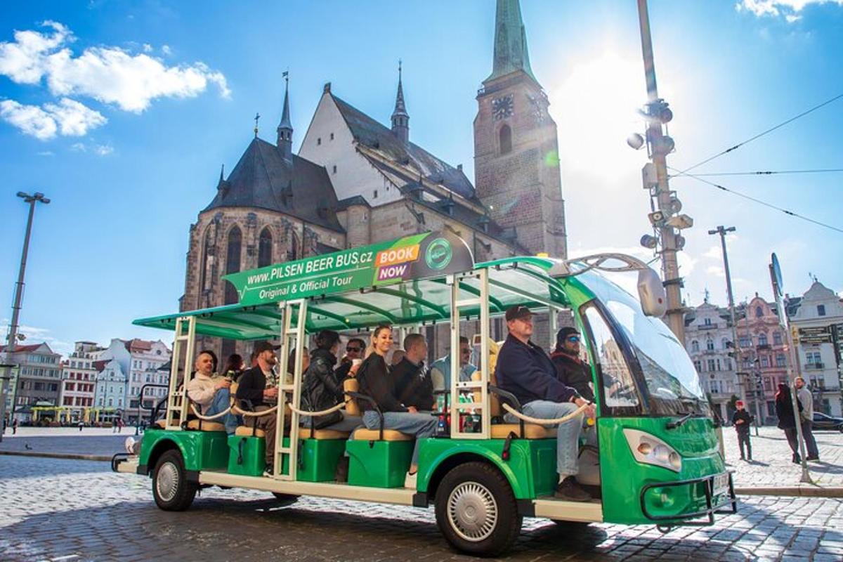 a group of people riding in a green trolley