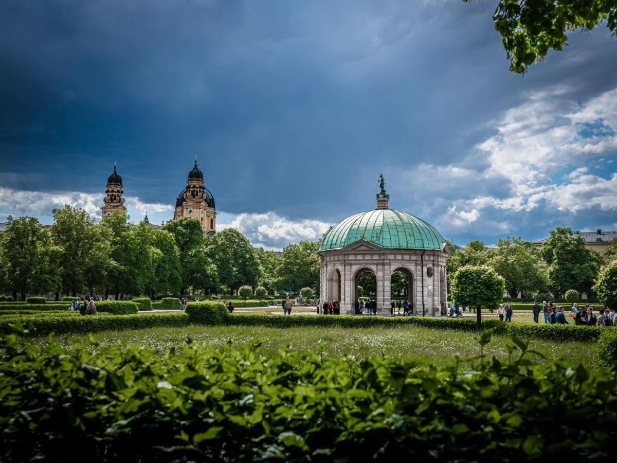 a gazebo in a park with two towers