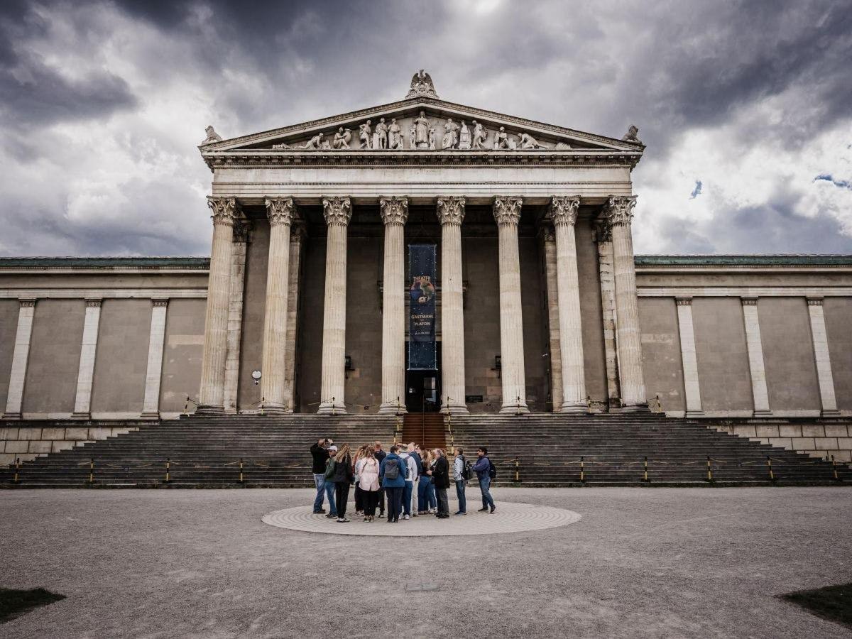 a group of people standing in front of a large building