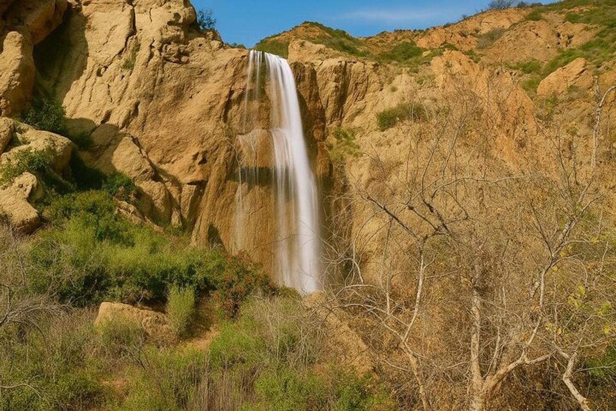 a waterfall on the side of a rocky mountain