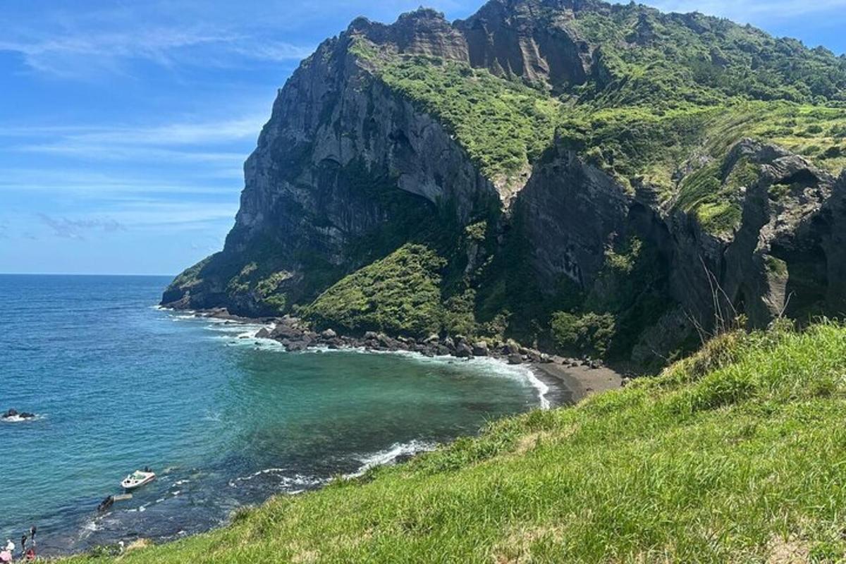 a view of a mountain with a beach and the ocean