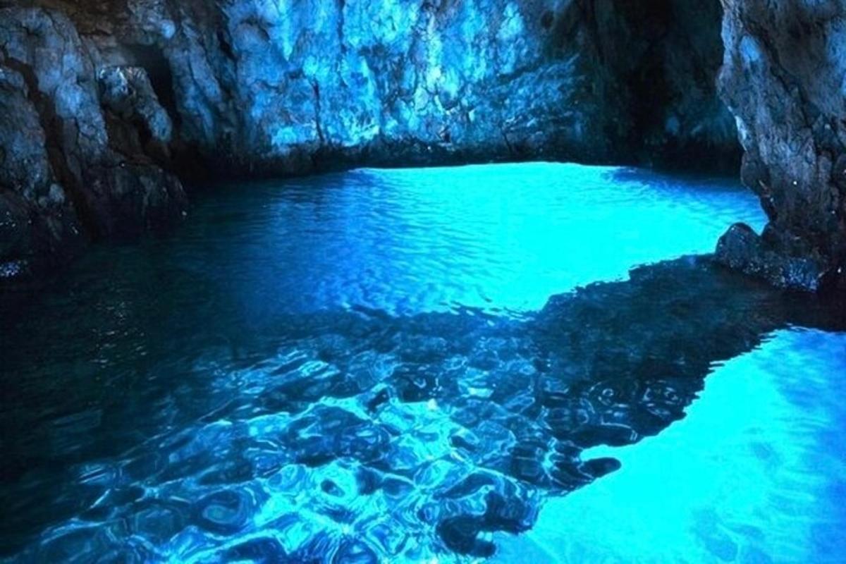 a pool of blue water in a cave