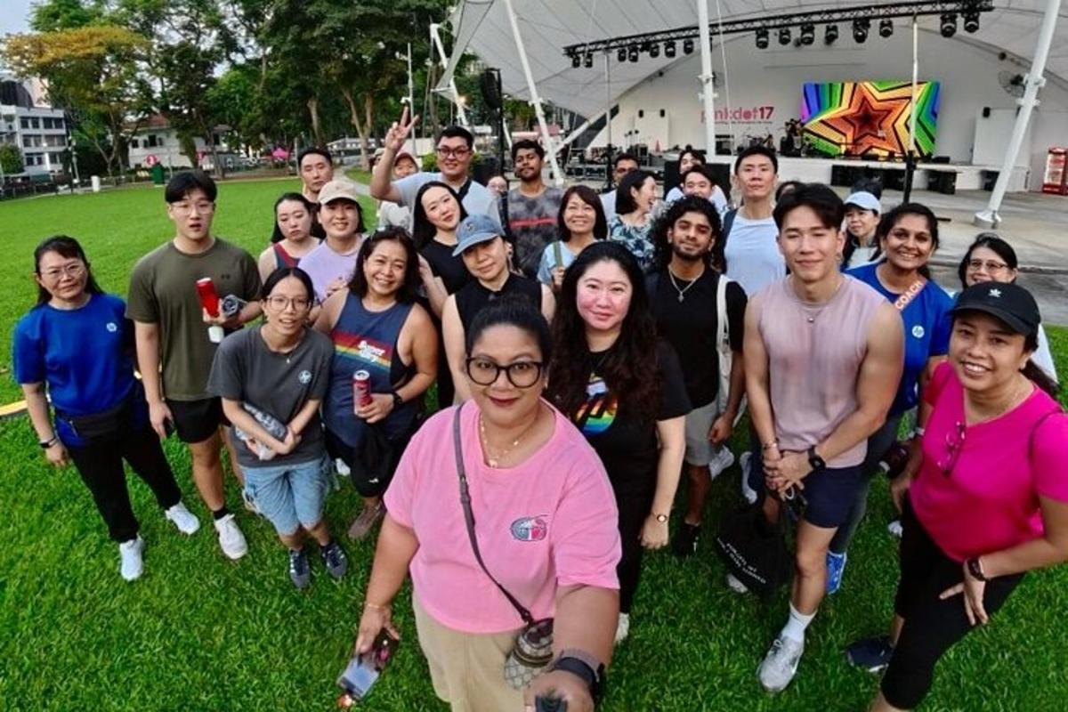 a group of people posing for a picture on the grass