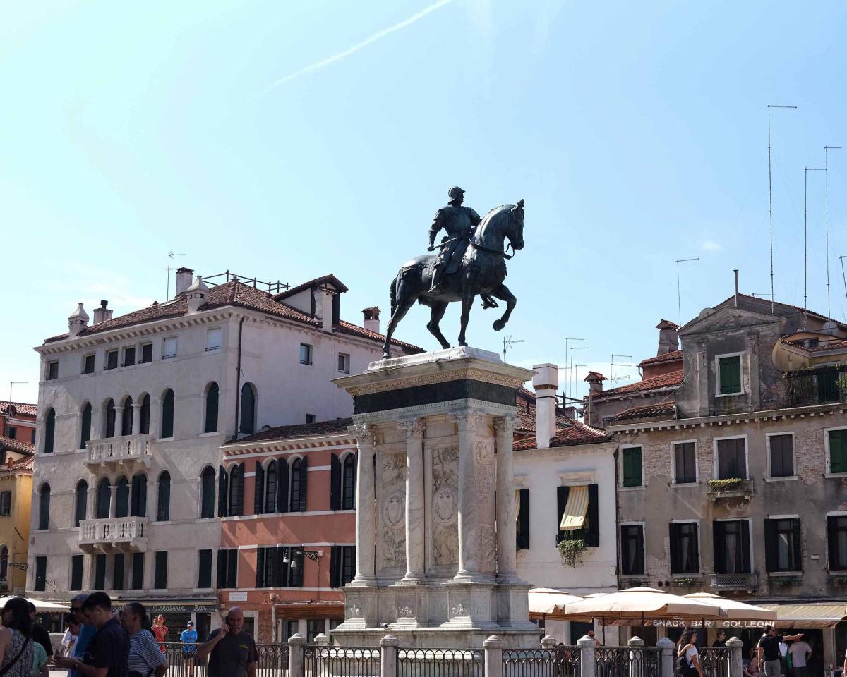 a statue of a man on a horse in a city