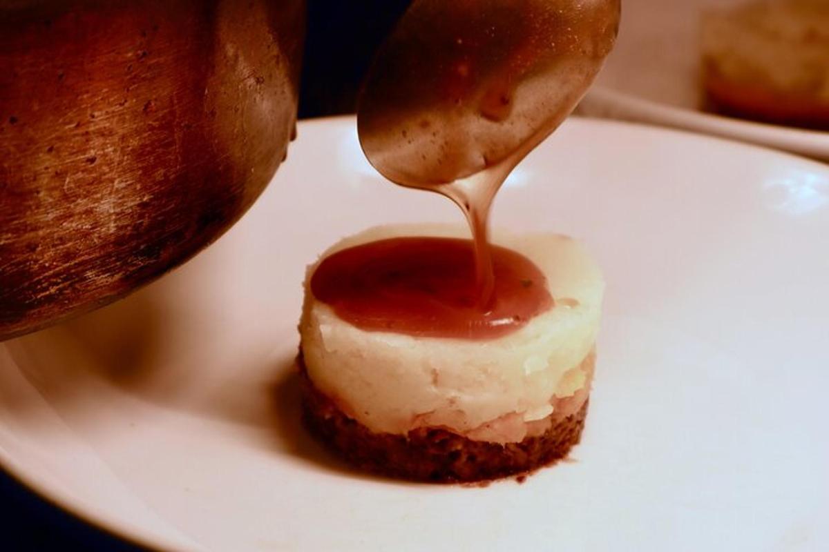 a spoon with a piece of food on a white plate