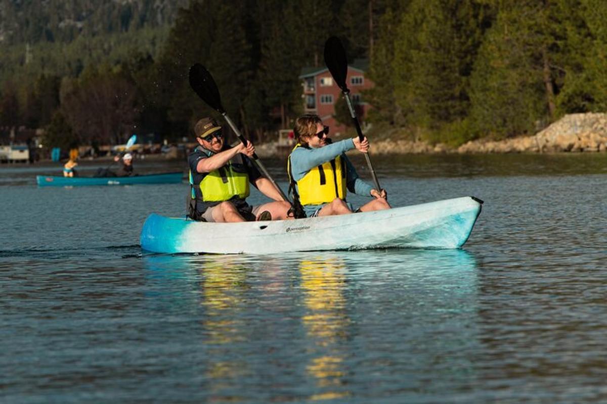 three people in a canoe on a lake