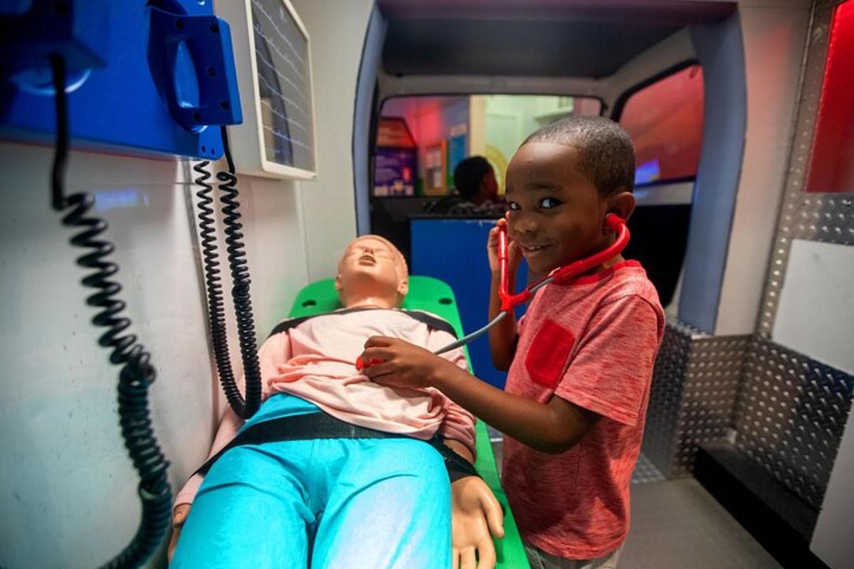 a young boy listening to a baby on a train