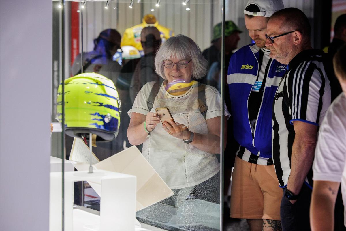 a woman looking at her cell phone in a store