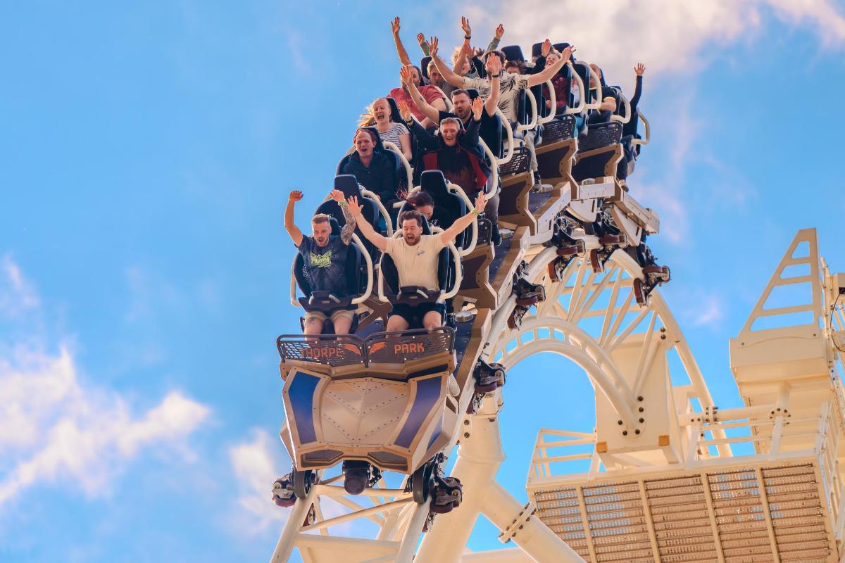 a group of people riding on a roller coaster