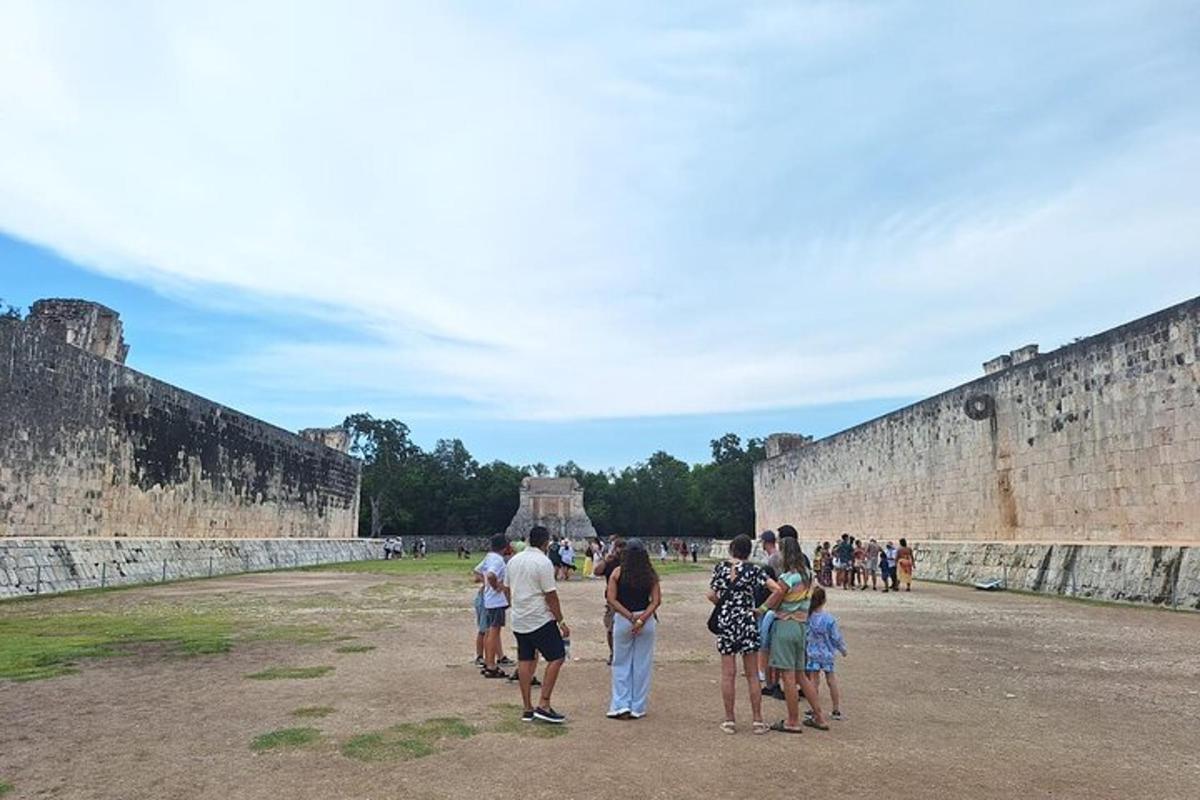 a group of people standing outside of a wall