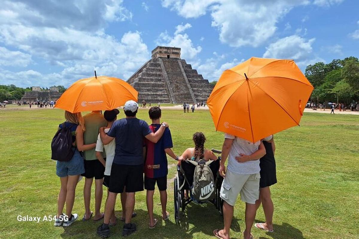 a group of people standing in front of a pyramid