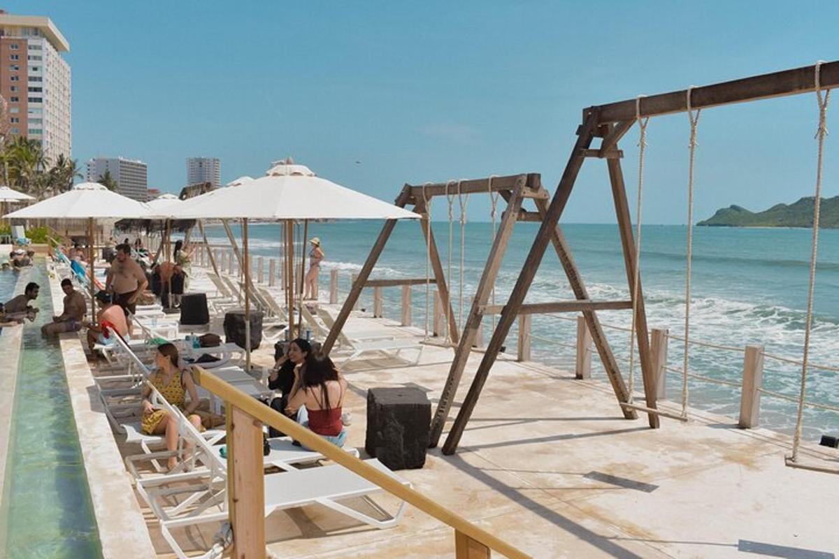 a group of people sitting on chairs at the beach