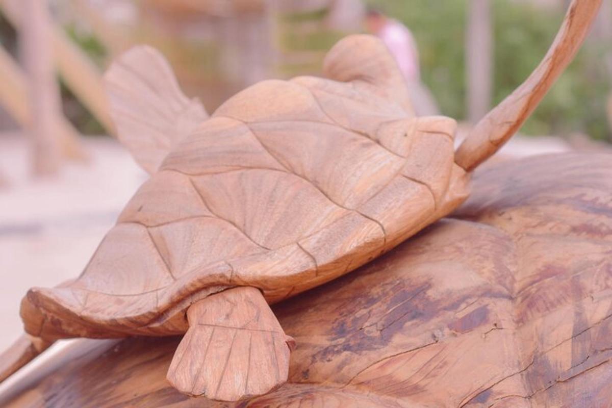 a turtle carved onto the back of a wooden object