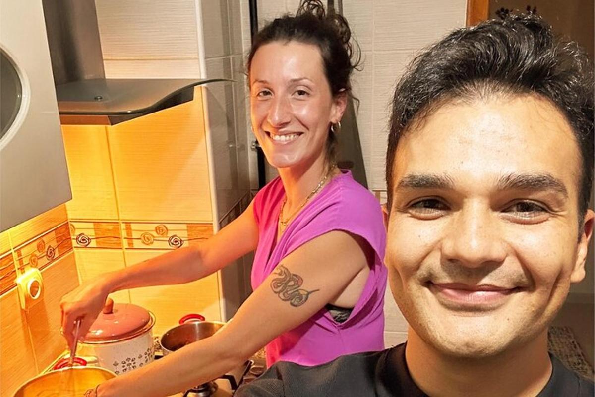 a woman standing next to a man in a kitchen