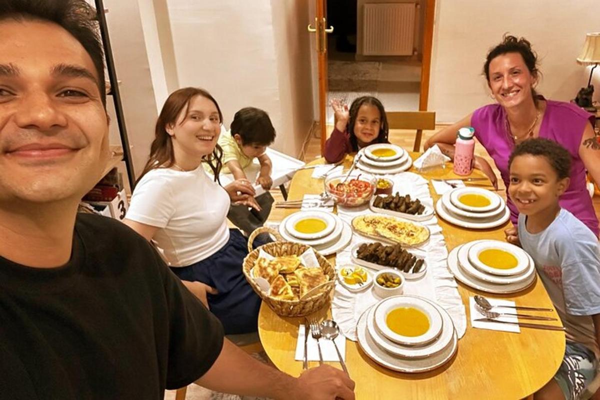 a group of people sitting around a table with food