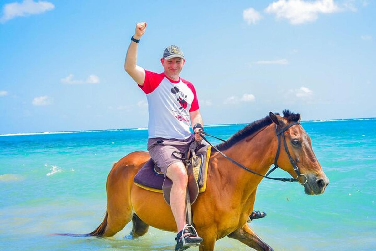 a man riding a horse on the beach