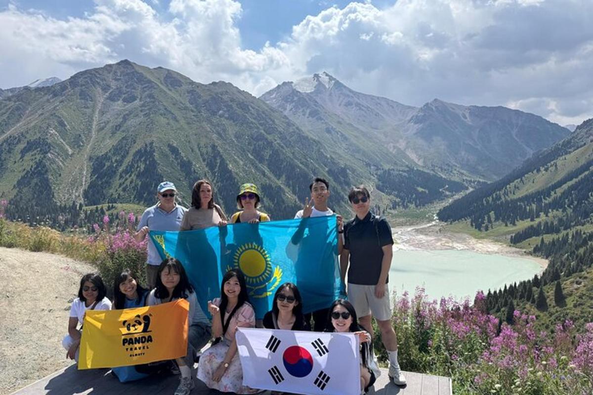 a group of people holding a flag on top of a mountain
