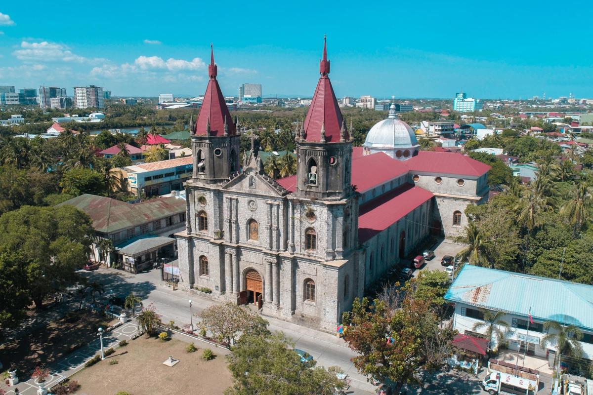 an old church with red towers in a city