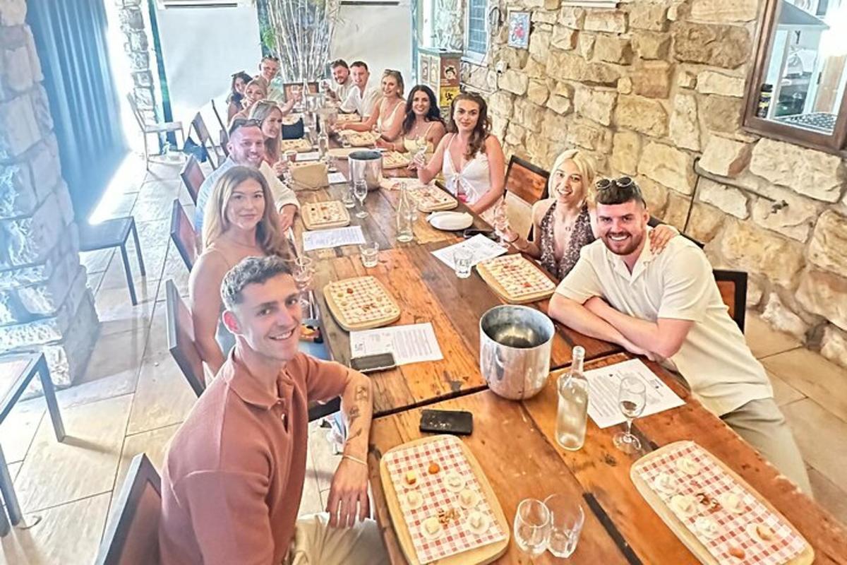 a group of people sitting around a wooden table