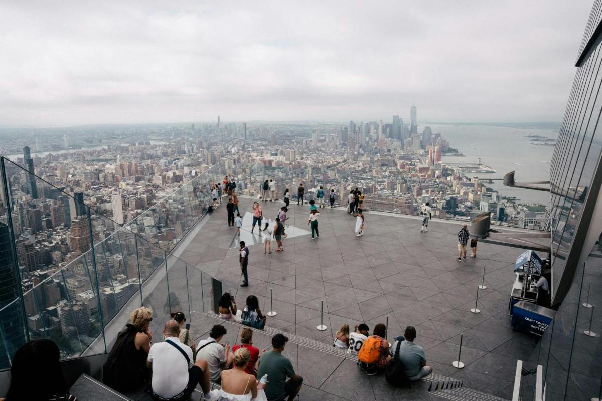 a group of people standing on the edge of the observation deck