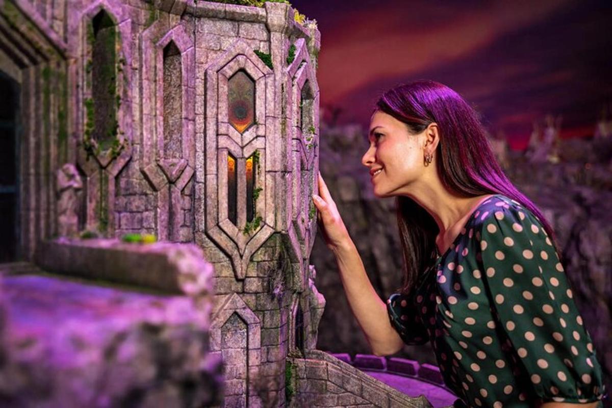 a woman with purple hair standing next to a castle