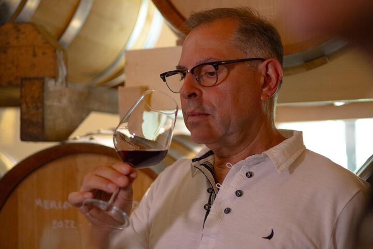 a man holding a glass of red wine