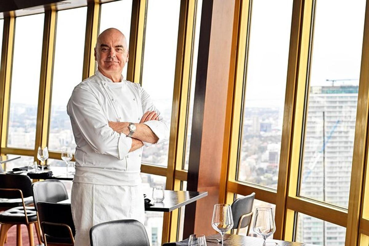 a man standing in a restaurant with his arms crossed