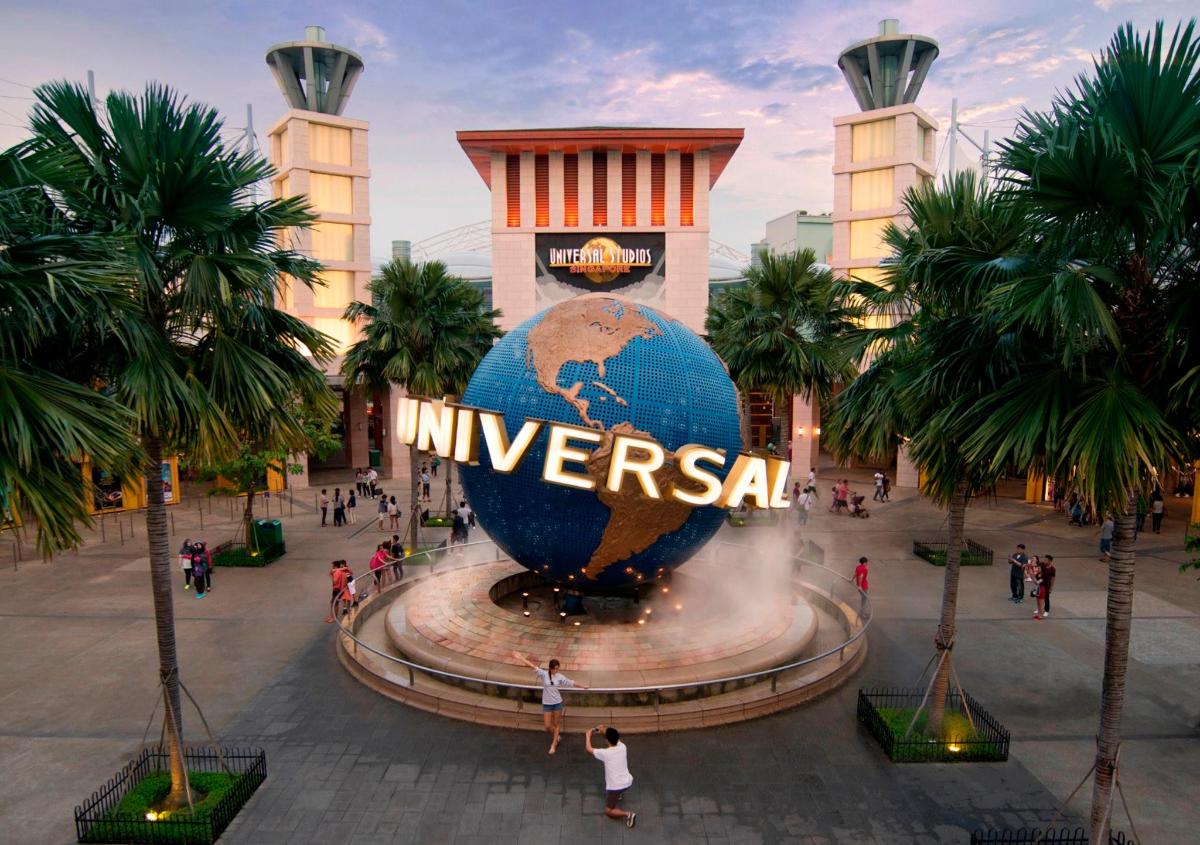 a sign in front of a globe in front of a building