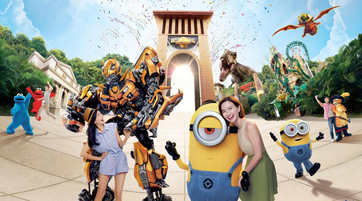 a woman and two children standing next to robots at a theme park