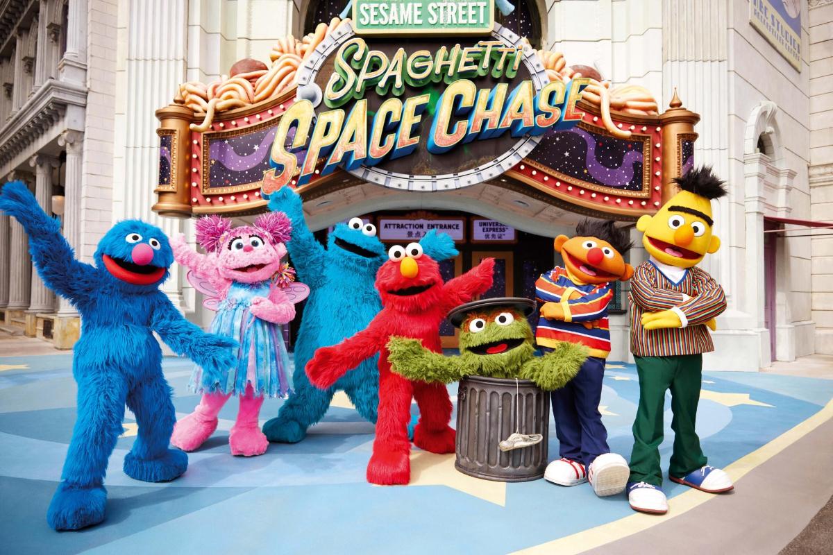 a group of stuffed animals standing in front of a theatre