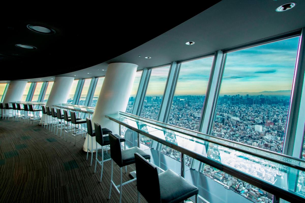 a row of chairs in a room with a city view