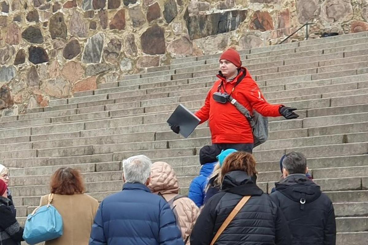 a man standing on the stairs with a crowd of people