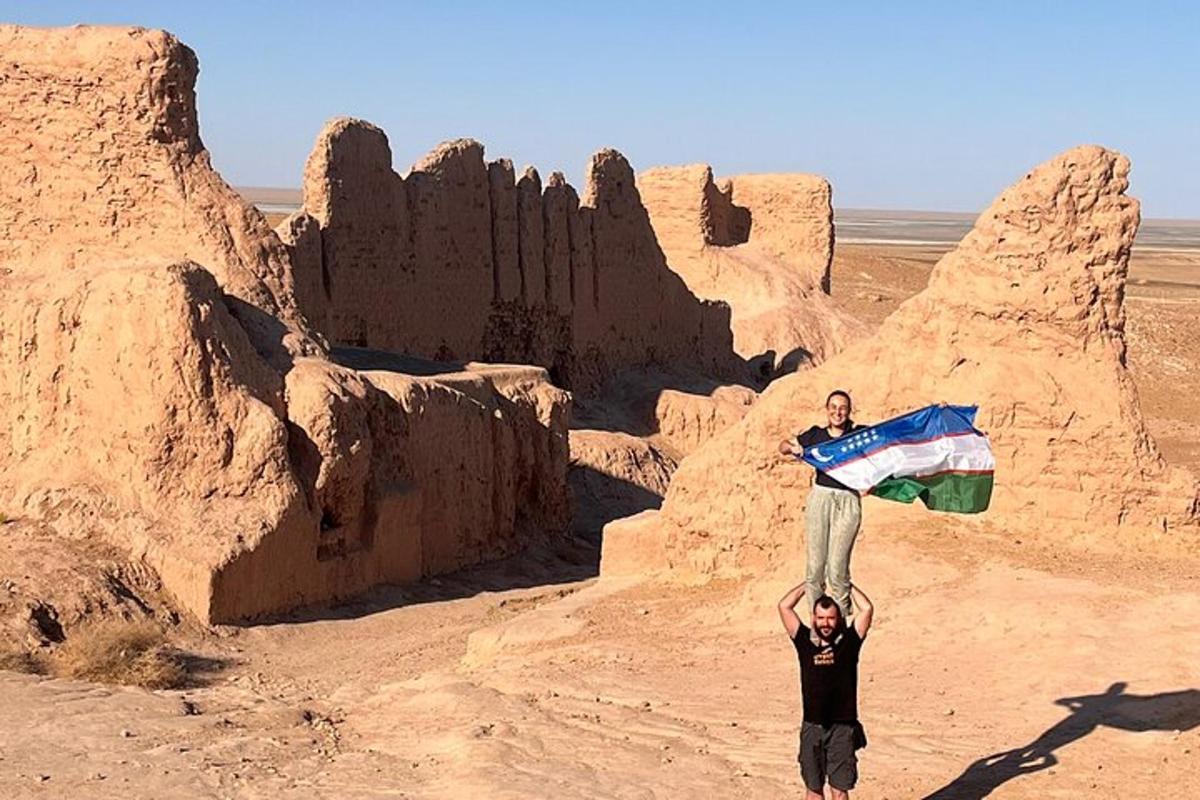 a man holding a flag in the desert