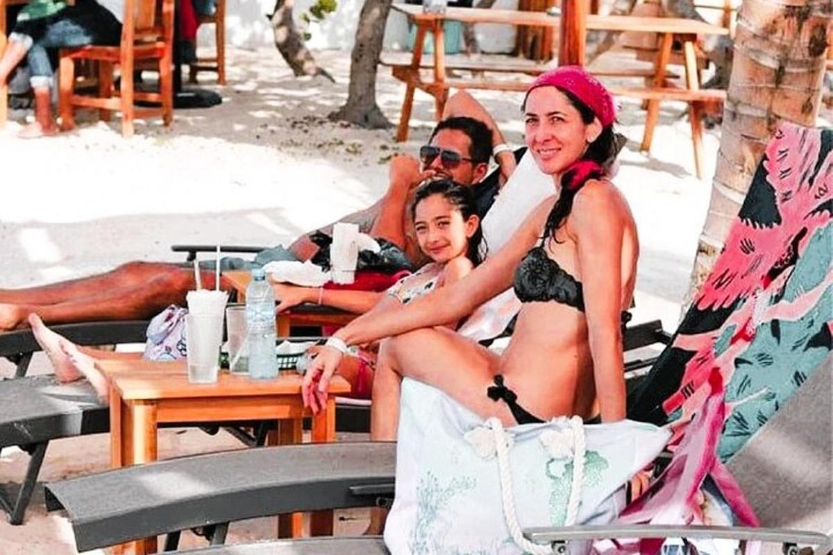 a woman sitting on a chair with a child