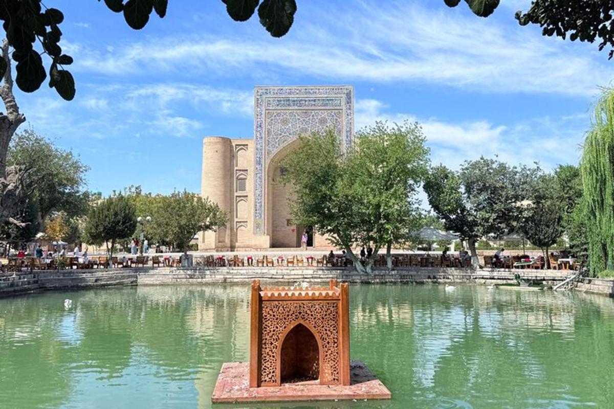 a building with a fountain in the middle of a pond