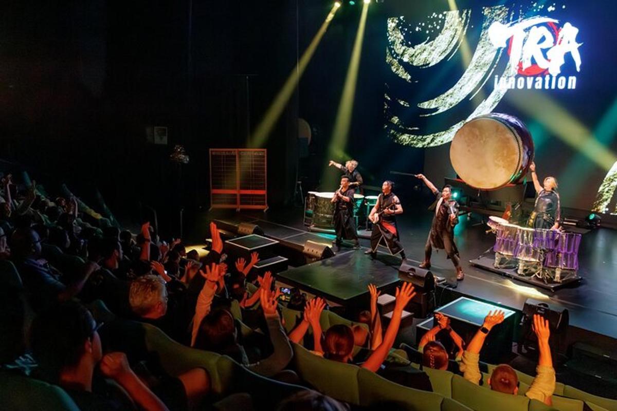 an audience watching a band playing on a stage
