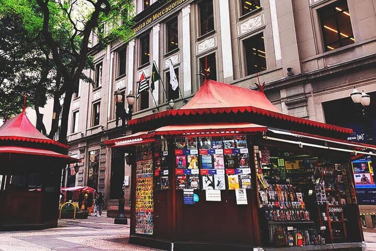 a kiosk on a city street with signs on it