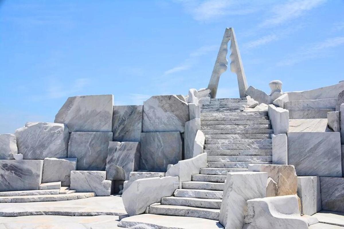 a large stone monument with a man sitting on top