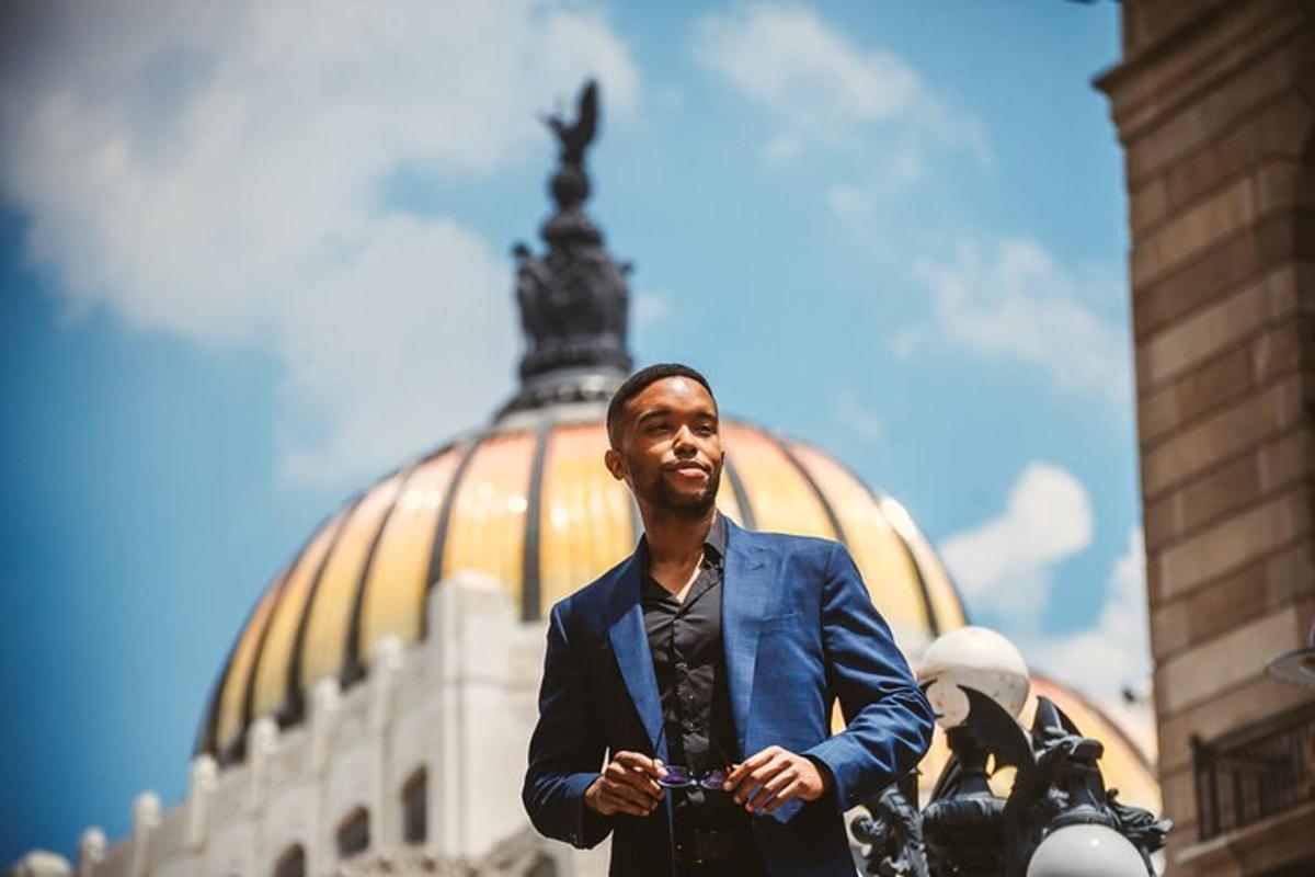 a man in a suit standing in front of a building