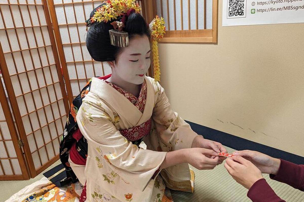 a woman in a kimono giving a person something
