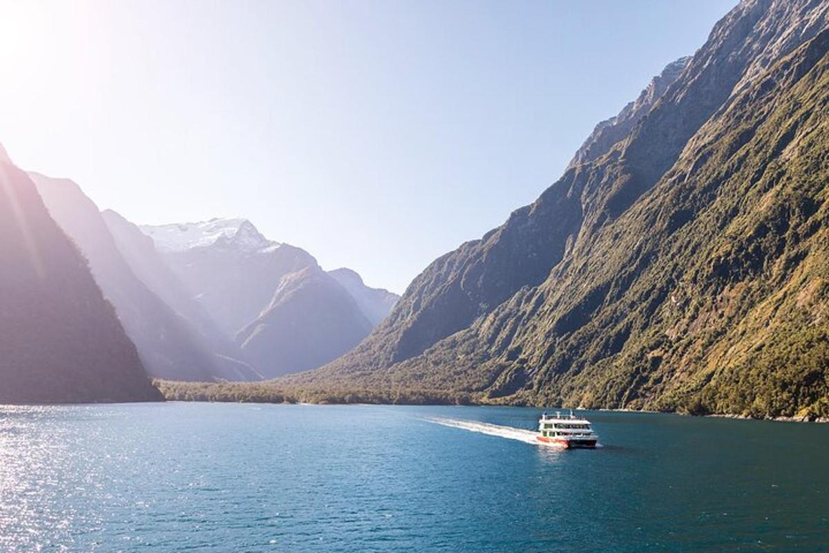 a boat in the middle of a river between mountains