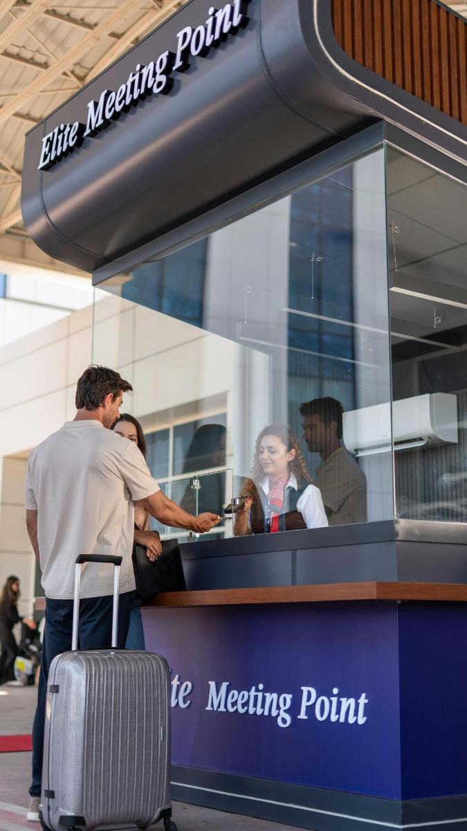a man with a suitcase standing in front of a meeting point