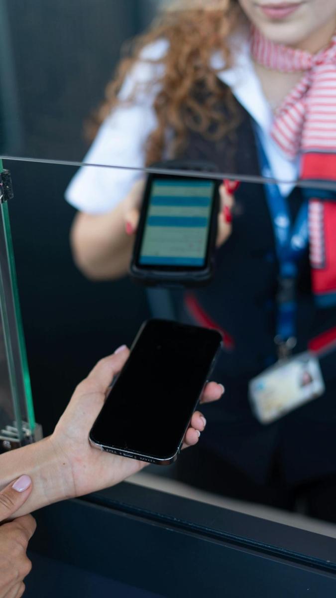 a person holding a cell phone in their hand