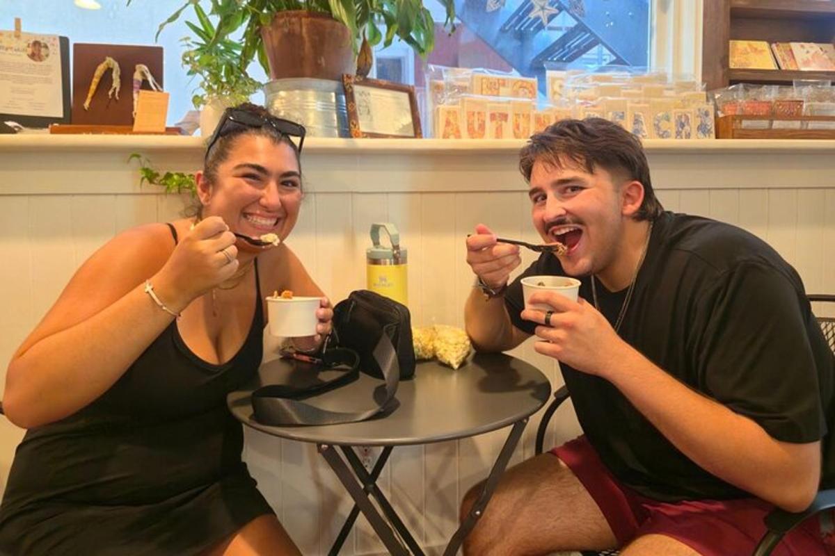 a man and woman sitting at a table brushing their teeth