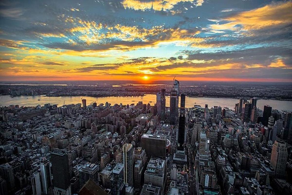 an aerial view of a large city at sunset