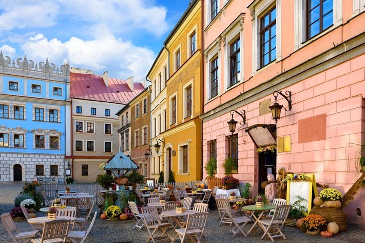 a courtyard with tables and chairs and buildings