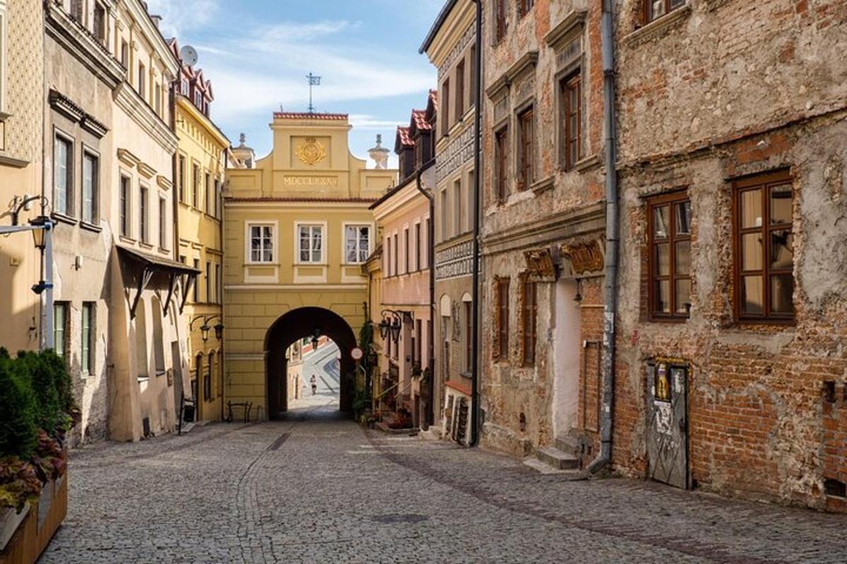 an alley with a building with a clock tower