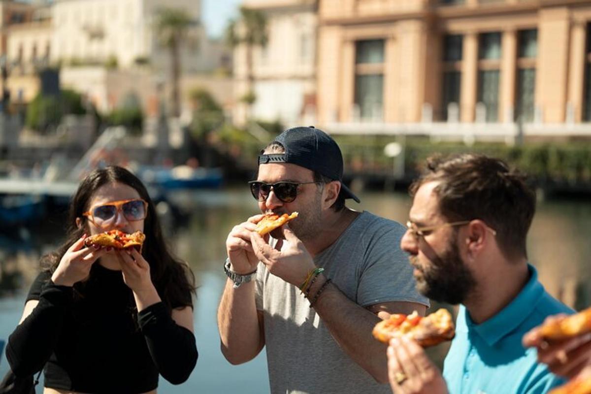 a group of three people eating slices of pizza