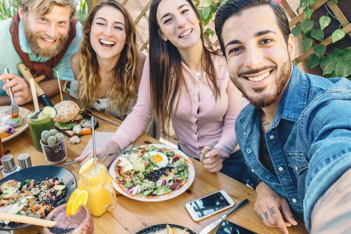 a group of people sitting at a table eating food