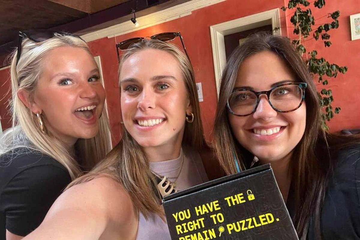 three women are holding a sign that says you have the right to remain pulled